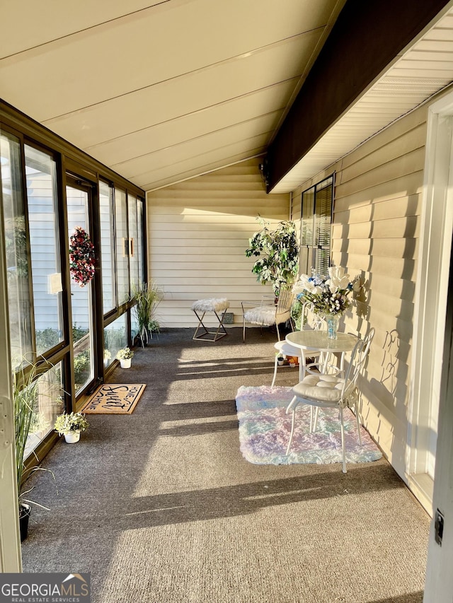 unfurnished sunroom with lofted ceiling