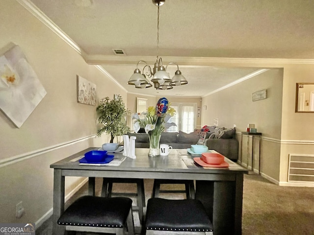 carpeted dining area with baseboards, visible vents, a chandelier, and ornamental molding