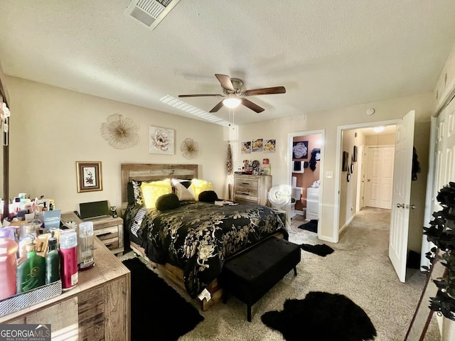 bedroom featuring a textured ceiling, a ceiling fan, visible vents, and light colored carpet