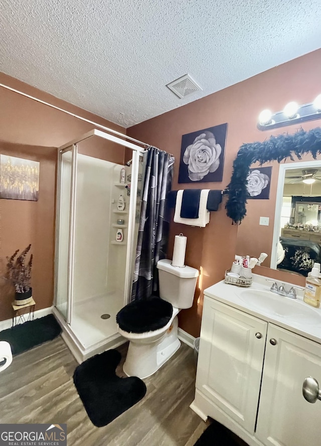 full bathroom with wood finished floors, a shower stall, and visible vents