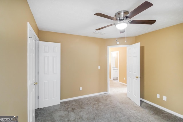 unfurnished bedroom with carpet, visible vents, baseboards, and a ceiling fan