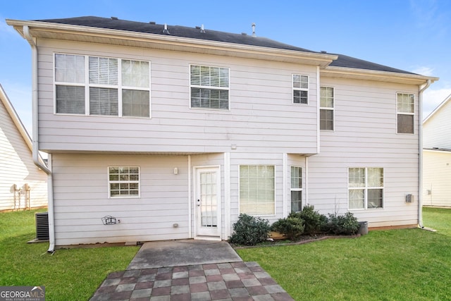 rear view of house with a yard