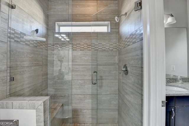 full bathroom featuring a stall shower and vanity