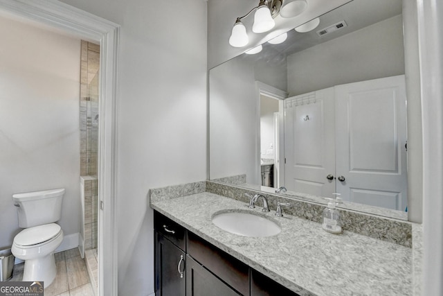 full bathroom featuring toilet, baseboards, visible vents, and vanity