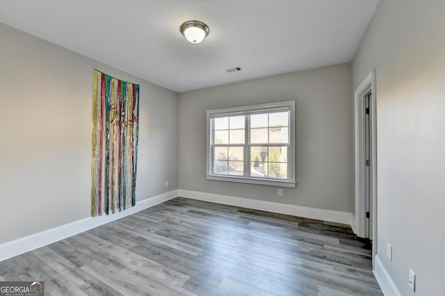 unfurnished room featuring wood finished floors and baseboards