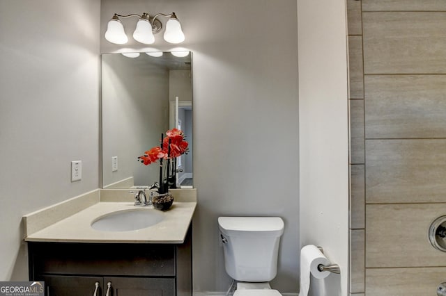 bathroom featuring vanity and toilet