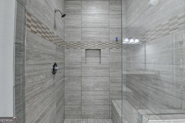 bathroom with a tile shower