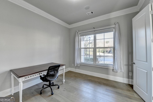 office area with baseboards, wood finished floors, visible vents, and crown molding