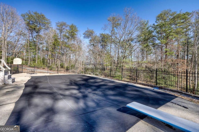 view of pool featuring fence