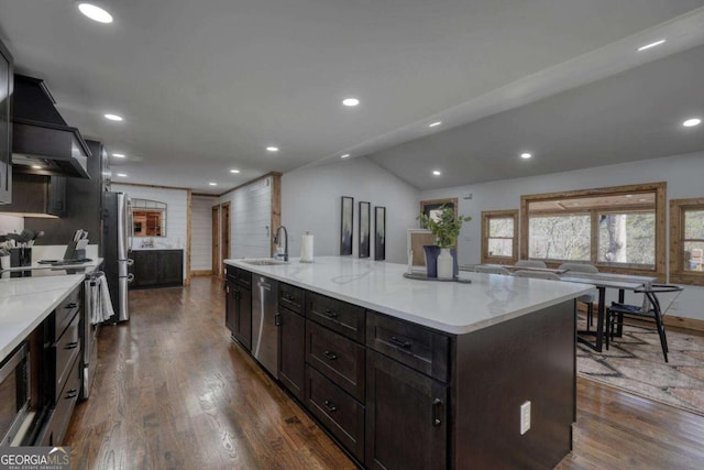 kitchen with appliances with stainless steel finishes, recessed lighting, dark wood-style flooring, and a sink