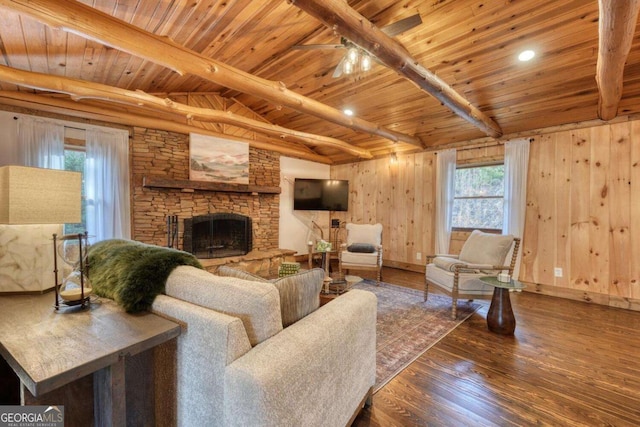 living area featuring a wealth of natural light, wooden ceiling, a fireplace, and wood finished floors