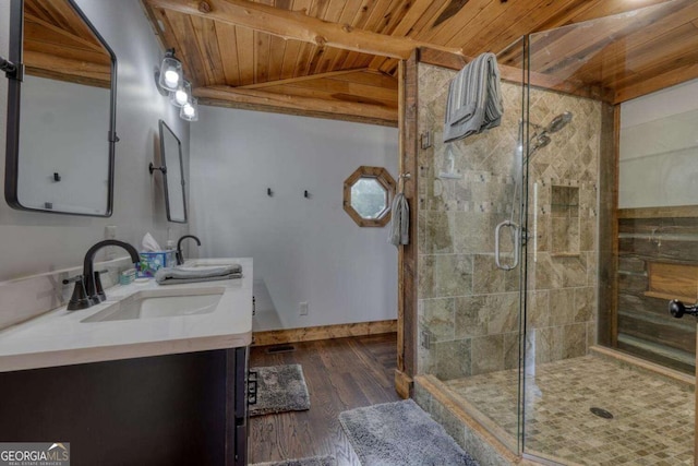 bathroom with a stall shower, wood ceiling, a sink, and wood finished floors