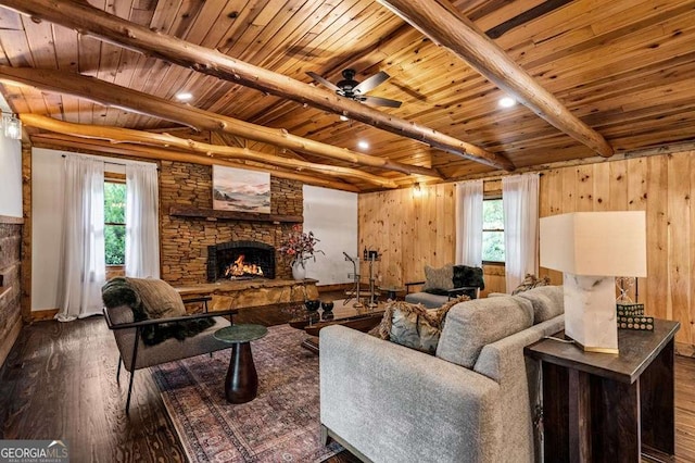 living room with beam ceiling, a fireplace, wood ceiling, a healthy amount of sunlight, and hardwood / wood-style flooring