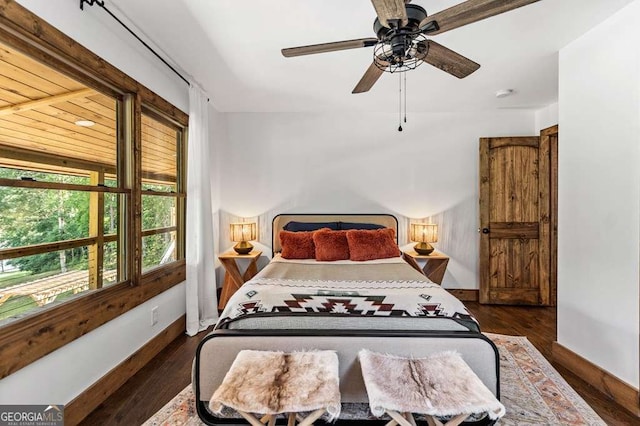 bedroom featuring wood finished floors, a ceiling fan, and baseboards