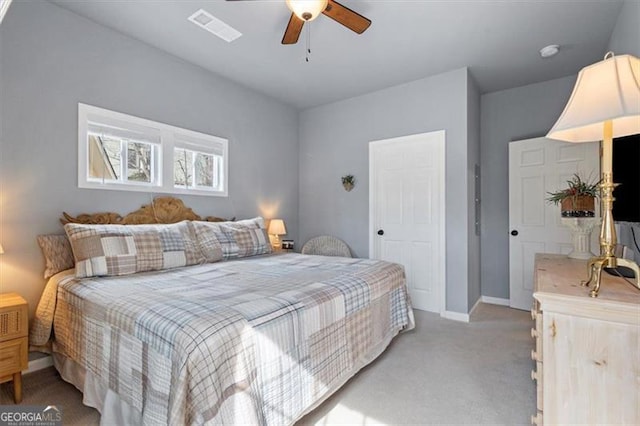 bedroom featuring visible vents, baseboards, a ceiling fan, and light colored carpet