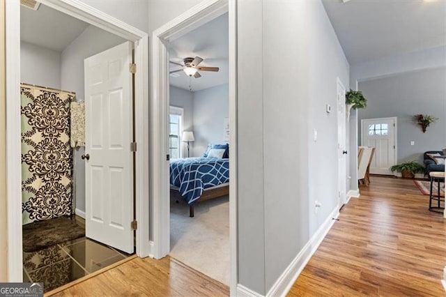 hall with wood finished floors and baseboards