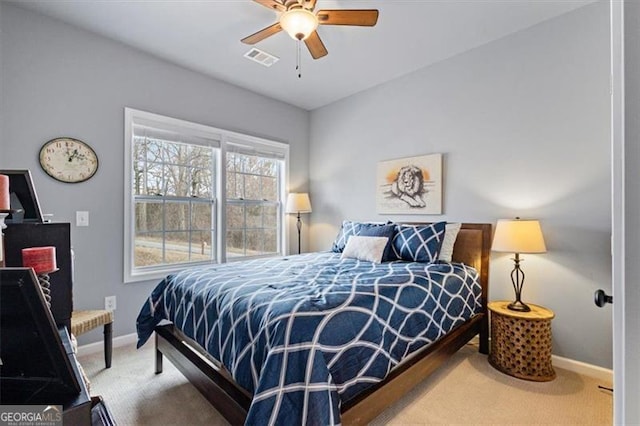 bedroom with carpet, visible vents, ceiling fan, and baseboards