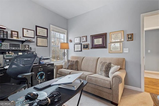 carpeted office featuring baseboards