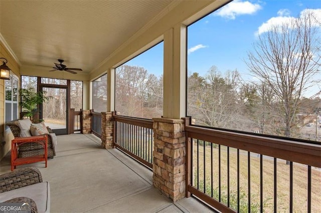 unfurnished sunroom featuring a ceiling fan