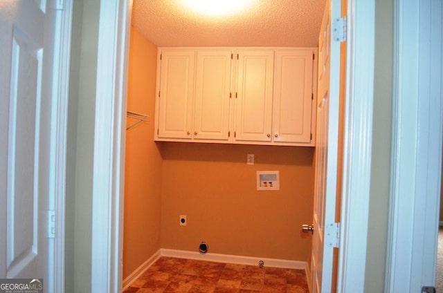 laundry room with a textured ceiling, hookup for a washing machine, baseboards, cabinet space, and electric dryer hookup