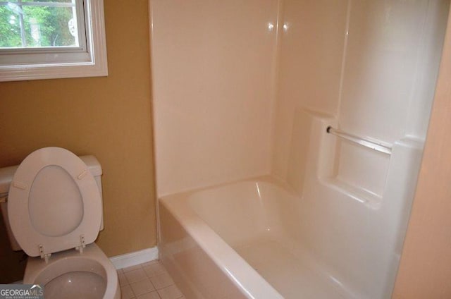 full bath with toilet, tile patterned flooring, and baseboards