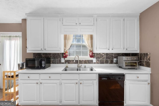 kitchen featuring a healthy amount of sunlight, black appliances, white cabinets, and a sink