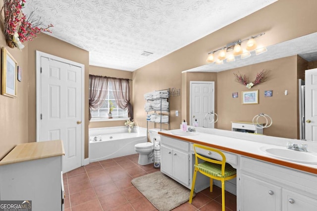 full bathroom featuring double vanity, tile patterned flooring, a textured ceiling, and a sink