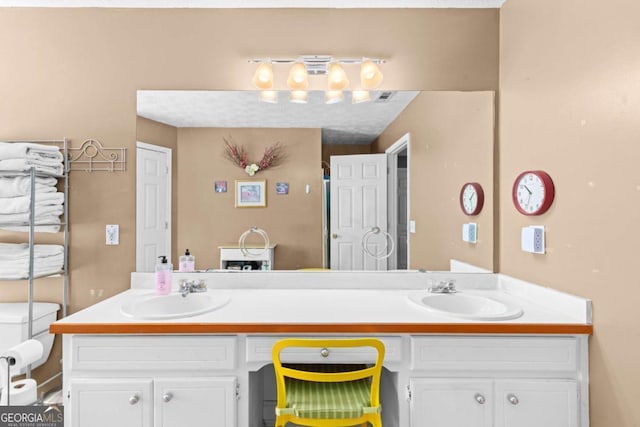 full bathroom with double vanity, a sink, and visible vents