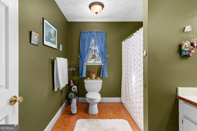 bathroom with a shower with curtain, toilet, vanity, tile patterned flooring, and baseboards