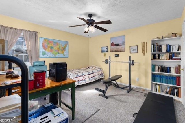 carpeted bedroom with ceiling fan, a textured ceiling, and baseboards