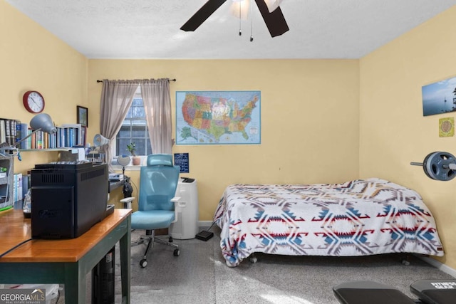 bedroom featuring ceiling fan, baseboards, and a textured ceiling