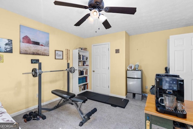 exercise room featuring carpet floors and baseboards