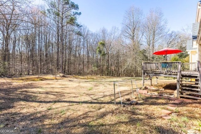 view of yard featuring stairway and a wooden deck