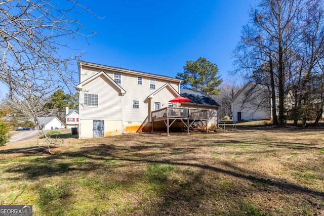 back of house with a yard and a wooden deck