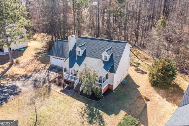 birds eye view of property with a view of trees