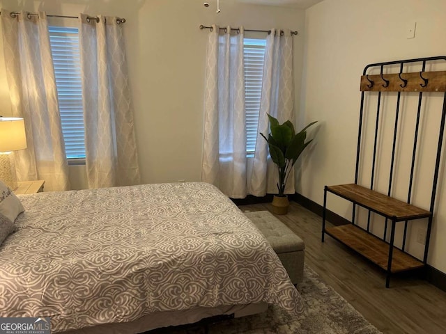 bedroom featuring wood finished floors and baseboards