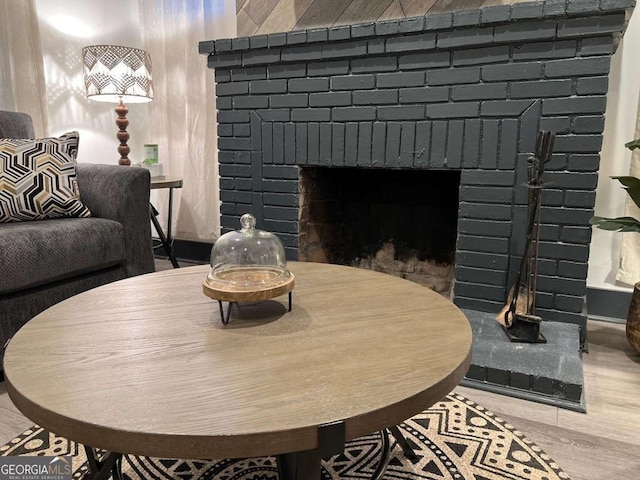 dining room featuring a fireplace and wood finished floors