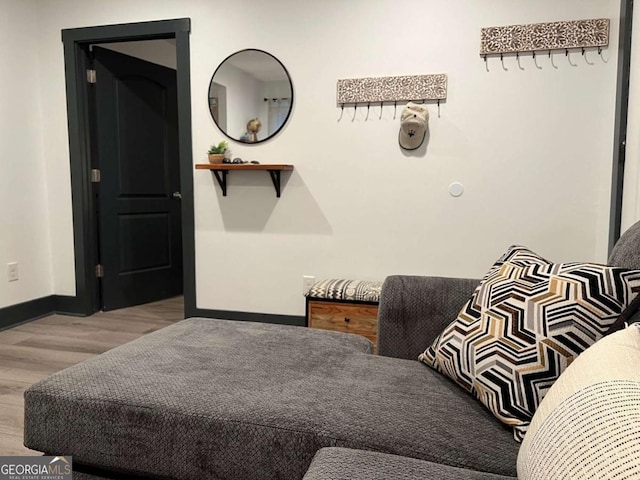 bedroom with baseboards and wood finished floors