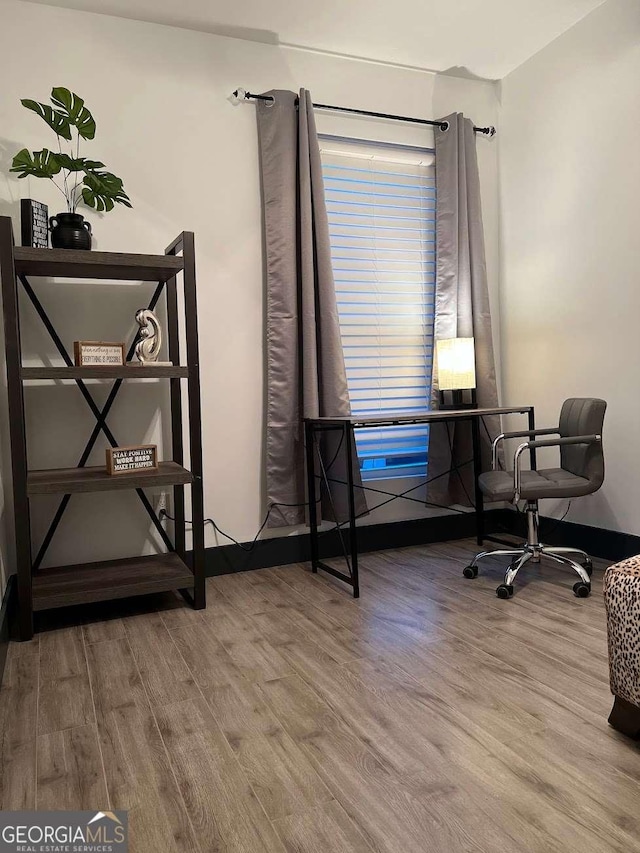 office area featuring wood finished floors and baseboards