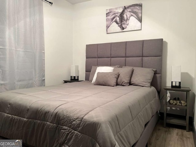 bedroom with wood finished floors