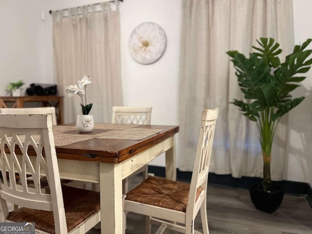 dining space with wood finished floors