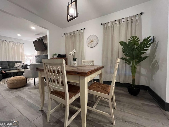 dining room with baseboards and wood finished floors