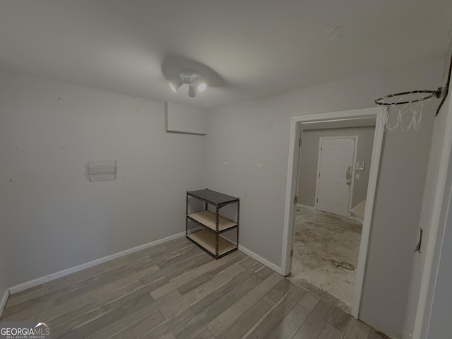 unfurnished room with light wood finished floors and baseboards