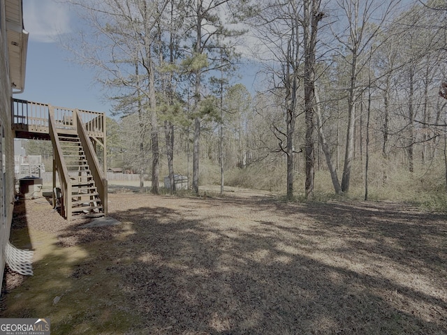 view of yard with stairway and a wooden deck