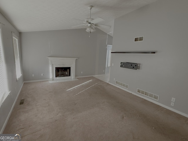 unfurnished living room with a glass covered fireplace and visible vents