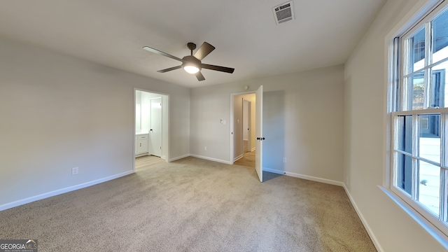 unfurnished bedroom with baseboards, multiple windows, and visible vents