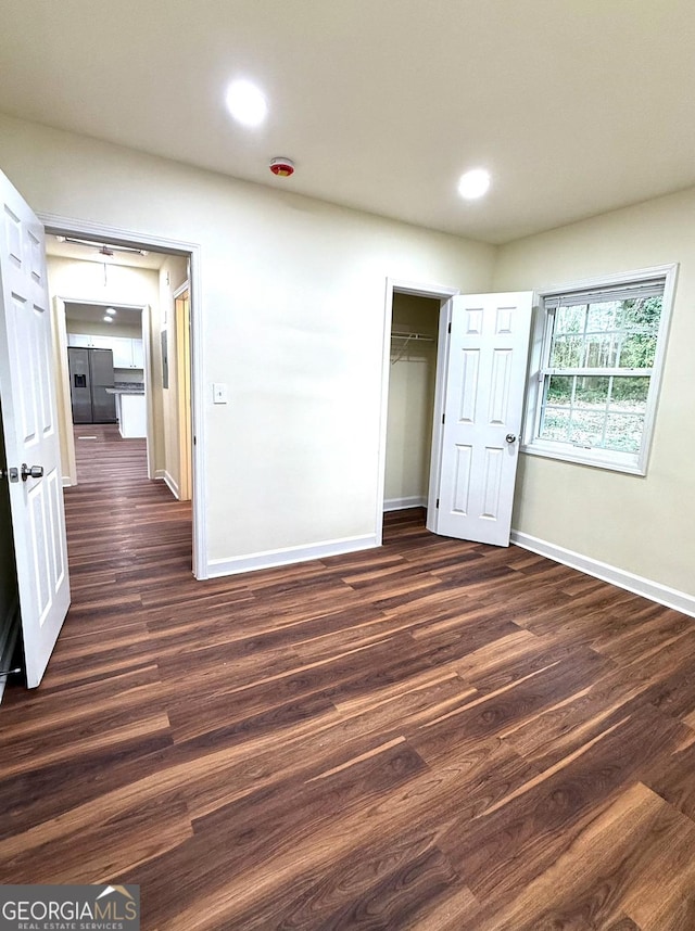 interior space with dark wood-style floors, recessed lighting, and baseboards