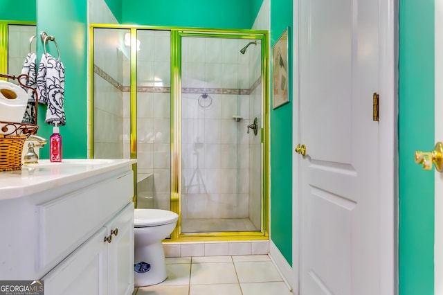 bathroom with toilet, a stall shower, tile patterned flooring, and vanity