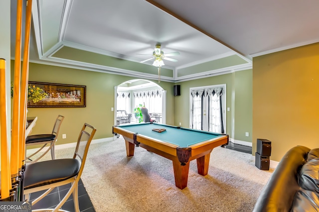 playroom featuring ceiling fan, carpet flooring, baseboards, a tray ceiling, and crown molding