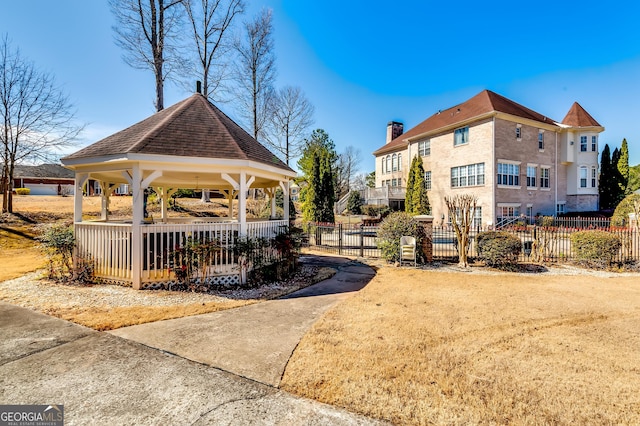 surrounding community featuring fence and a gazebo